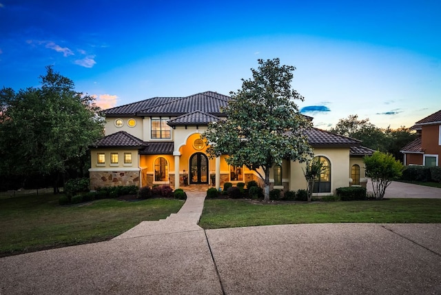 4020 Texas Wildlife Trl, Austin, TX 78735 - mediterranean / spanish-style house featuring a front lawn, stucco siding, and a tiled roof