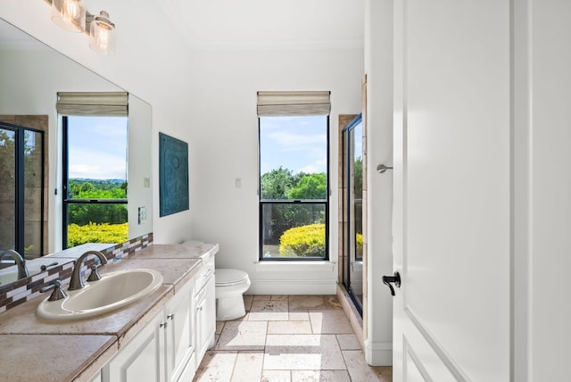 4020 Texas Wildlife Trl, Austin, TX 78735 - bathroom featuring ornamental molding, a shower stall, vanity, toilet, and stone tile floors