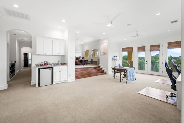 4020 Texas Wildlife Trl, Austin, TX 78735 - kitchen with light colored carpet, arched walkways, a ceiling fan, refrigerator, and recessed lighting