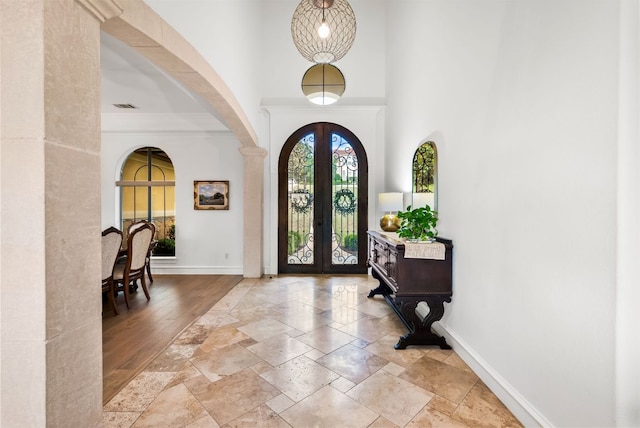 4020 Texas Wildlife Trl, Austin, TX 78735 - foyer entrance featuring stone tile floors, a high ceiling, french doors, and arched walkways