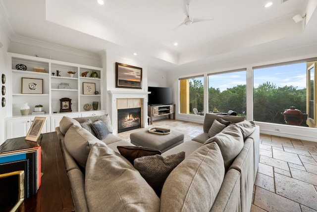 4020 Texas Wildlife Trl, Austin, TX 78735 - living area featuring a tray ceiling, stone tile flooring, recessed lighting, crown molding, and a tile fireplace