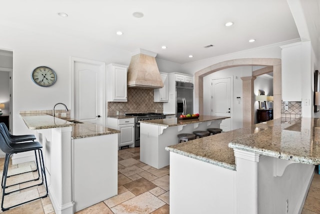 4020 Texas Wildlife Trl, Austin, TX 78735 - kitchen featuring custom range hood, stainless steel appliances, a kitchen breakfast bar, a kitchen island, and crown molding