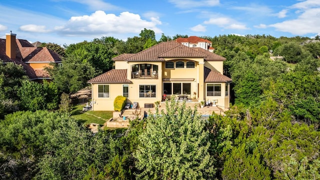4020 Texas Wildlife Trl, Austin, TX 78735 - back of house with stucco siding, a tile roof, and a patio