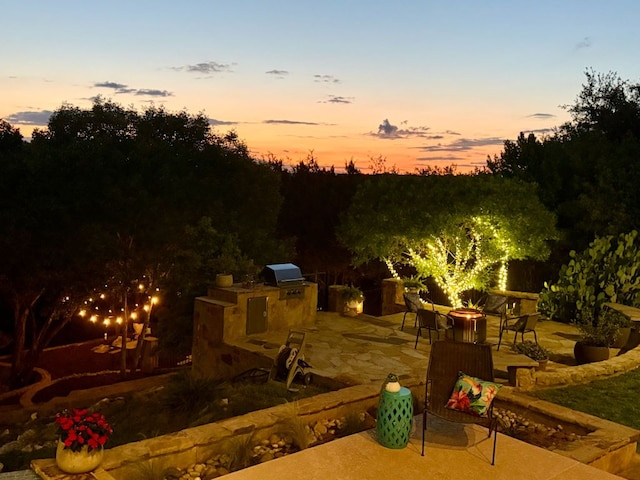 4020 Texas Wildlife Trl, Austin, TX 78735 - patio terrace at dusk featuring exterior kitchen