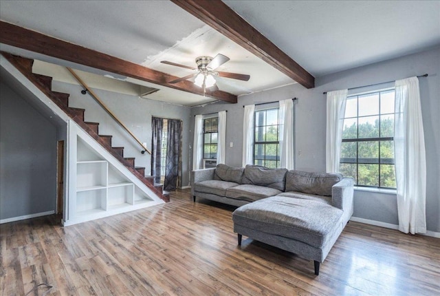990 Oak Mdws, San Marcos, TX 78666 - living room with wood finished floors, baseboards, beam ceiling, ceiling fan, and stairs