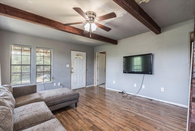 990 Oak Mdws, San Marcos, TX 78666 - living area featuring beam ceiling, wood finished floors, a ceiling fan, and baseboards