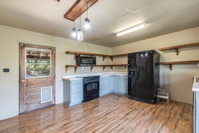 990 Oak Mdws, San Marcos, TX 78666 - kitchen featuring open shelves, black appliances, light countertops, and light wood finished floors