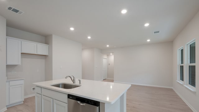 329 Lone Cedar Rd, Marble Falls, TX 78654 - kitchen featuring a sink, stainless steel dishwasher, white cabinets, light wood-style floors, and a kitchen island with sink