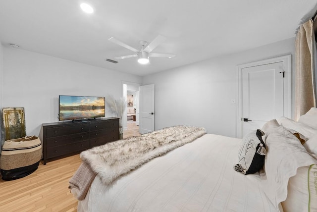 bedroom featuring light wood finished floors, ceiling fan, and recessed lighting