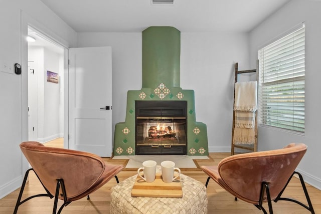 living area with plenty of natural light, baseboards, and wood finished floors