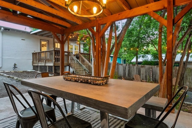 sunroom / solarium featuring a chandelier and beam ceiling