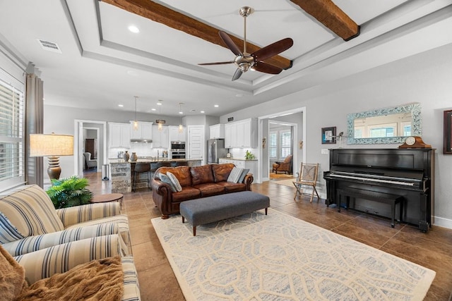 128 Tuscany Way, Georgetown, TX 78633 - tiled living area featuring ceiling fan, recessed lighting, baseboards, a tray ceiling, and a sink