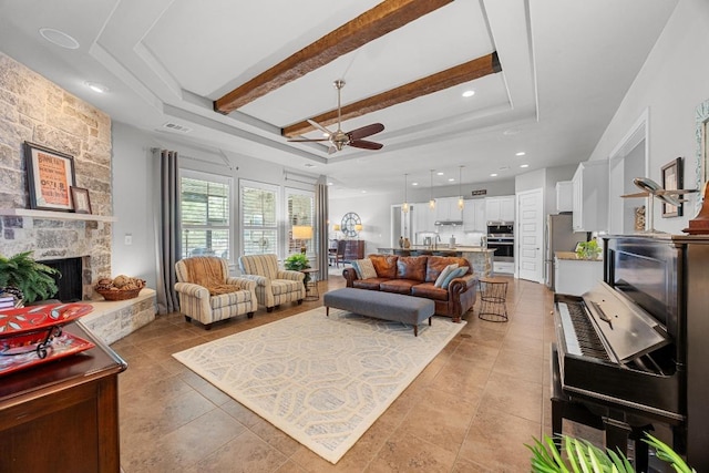 128 Tuscany Way, Georgetown, TX 78633 - living room featuring a tray ceiling, ceiling fan, a fireplace, light tile patterned flooring, and recessed lighting