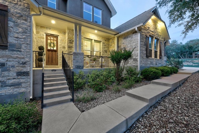 128 Tuscany Way, Georgetown, TX 78633 - property entrance with stone siding and a porch