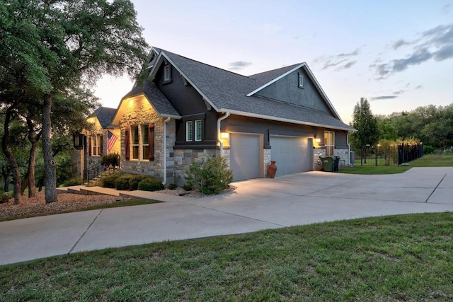 128 Tuscany Way, Georgetown, TX 78633 - view of home's exterior with stone siding, concrete driveway, a shingled roof, an attached garage, and stucco siding