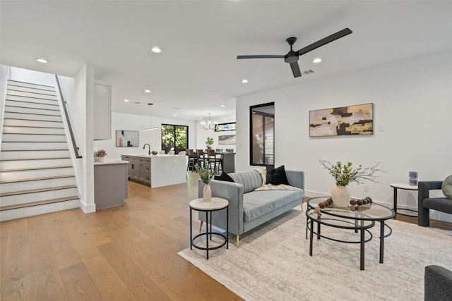 3705 Wilson St Unit 1, Austin, TX 78704 - living area with stairway, recessed lighting, light wood-style floors, a chandelier, and ceiling fan