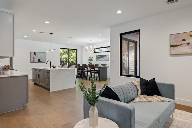 3705 Wilson St Unit 1, Austin, TX 78704 - living room with light wood finished floors, recessed lighting, and a chandelier