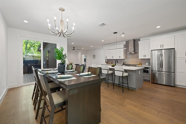 3705 Wilson St Unit 1, Austin, TX 78704 - dining room with wood finished floors, a chandelier, and recessed lighting