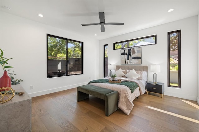 bedroom featuring wood finished floors, recessed lighting, baseboards, and a ceiling fan