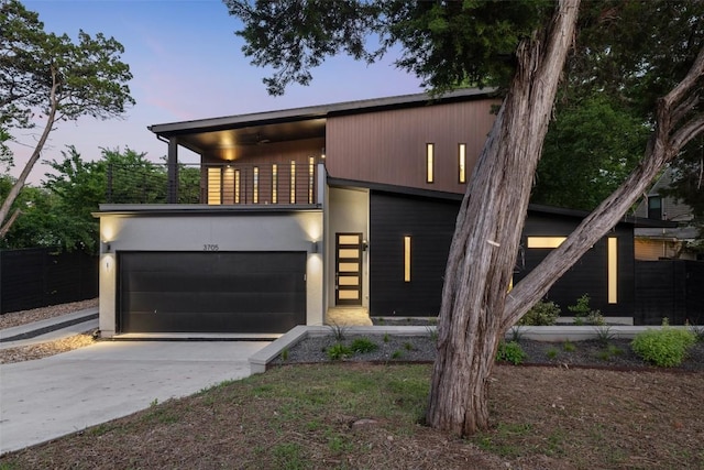 3705 Wilson St Unit 1, Austin, TX 78704 - contemporary home featuring a balcony, concrete driveway, a garage, and stucco siding