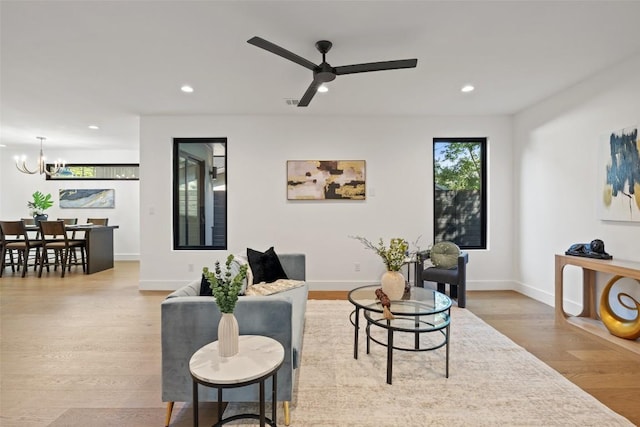 3705 Wilson St Unit 1, Austin, TX 78704 - living room featuring a chandelier, recessed lighting, a ceiling fan, and wood finished floors
