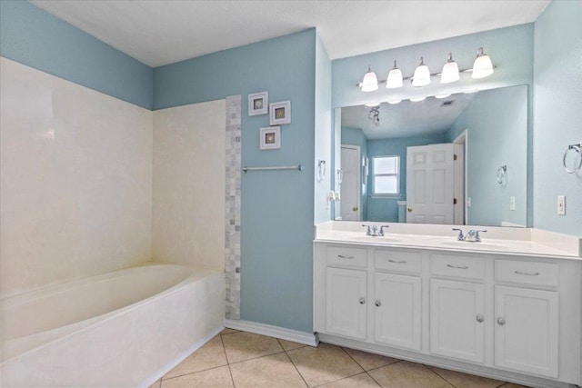 110 Hummingbird Ct, Cedar Creek, TX 78612 - full bathroom with tile patterned floors, a tub, double vanity, and baseboards