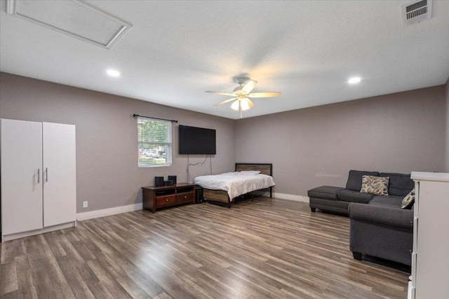 110 Hummingbird Ct, Cedar Creek, TX 78612 - bedroom with attic access, wood finished floors, baseboards, recessed lighting, and ceiling fan