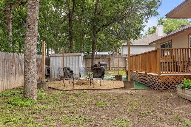 110 Hummingbird Ct, Cedar Creek, TX 78612 - fenced backyard with a storage shed, a deck, and an outdoor structure