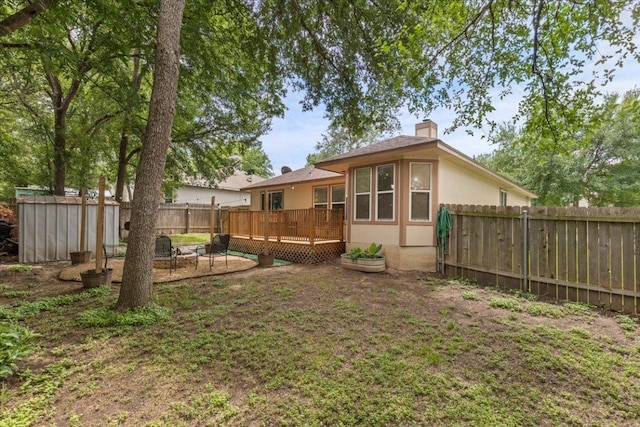110 Hummingbird Ct, Cedar Creek, TX 78612 - rear view of house featuring a shed, a fenced backyard, a deck, an outbuilding, and a chimney
