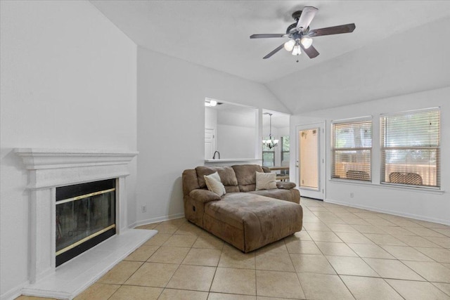 110 Hummingbird Ct, Cedar Creek, TX 78612 - living area with vaulted ceiling, a chandelier, light tile patterned flooring, a ceiling fan, and a glass covered fireplace