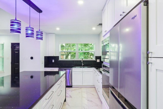 309 Northwood Dr, Georgetown, TX 78628 - kitchen with stainless steel appliances, light marble finish floors, white cabinets, recessed lighting, and dark stone counters