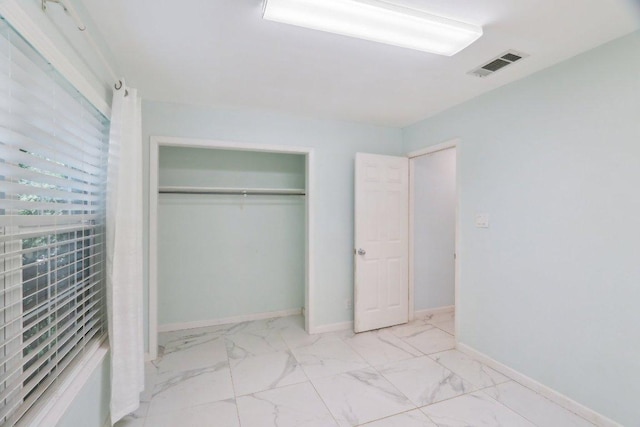 309 Northwood Dr, Georgetown, TX 78628 - unfurnished bedroom featuring marble finish floors and a closet