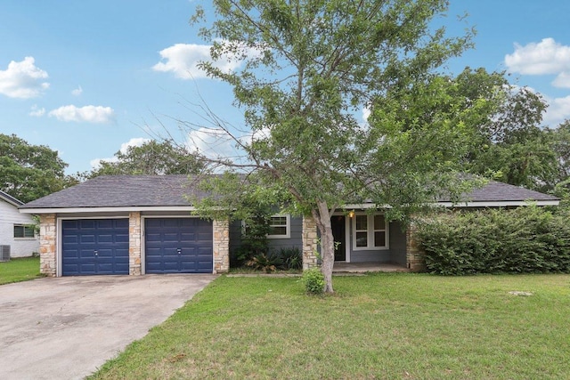 309 Northwood Dr, Georgetown, TX 78628 - view of front facade featuring an attached garage, driveway, a front lawn, and stone siding