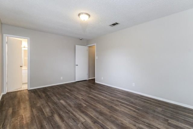 7301 Scenic Brook Dr, Austin, TX 78736 - unfurnished room featuring dark wood-style floors, baseboards, and a textured ceiling