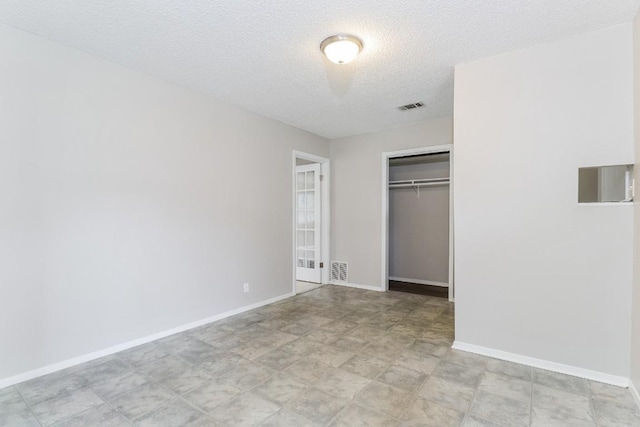7301 Scenic Brook Dr, Austin, TX 78736 - unfurnished bedroom with a closet, baseboards, and a textured ceiling