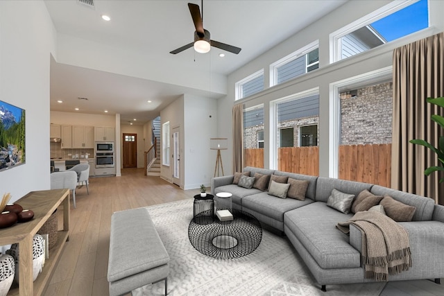 1352 S Brook Dr, Leander, TX 78641 - living room with a ceiling fan, stairway, light wood finished floors, and recessed lighting