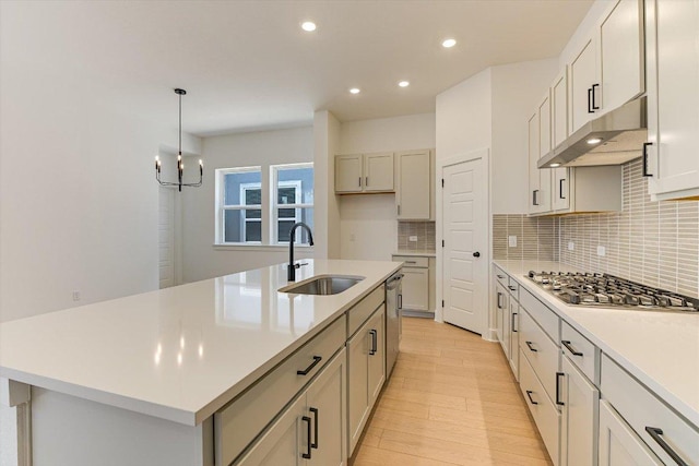 1352 S Brook Dr, Leander, TX 78641 - kitchen with a sink, appliances with stainless steel finishes, under cabinet range hood, decorative backsplash, and recessed lighting