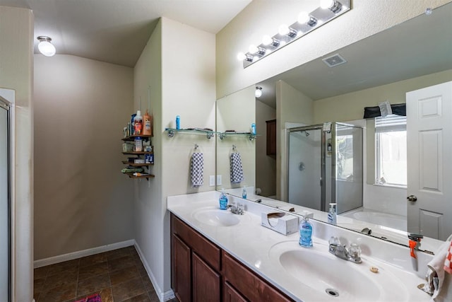 604 Comal Run, Hutto, TX 78634 - bathroom featuring a stall shower, double vanity, and a bath