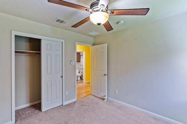 604 Comal Run, Hutto, TX 78634 - unfurnished bedroom with light colored carpet, a closet, and a ceiling fan