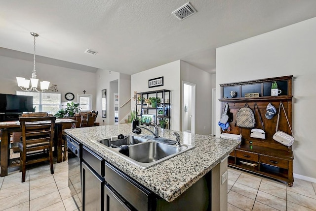 kitchen featuring a sink, open floor plan, black dishwasher, light tile patterned floors, and a chandelier