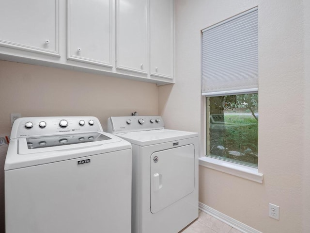 9402 Bluegrass Dr, Austin, TX 78759 - washroom featuring separate washer and dryer, cabinet space, and light tile patterned flooring