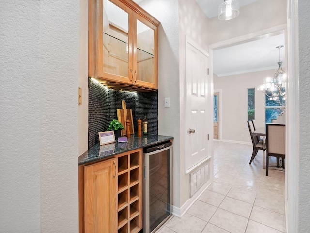 9402 Bluegrass Dr, Austin, TX 78759 - bar area featuring beverage cooler, a textured wall, light tile patterned flooring, a chandelier, and crown molding
