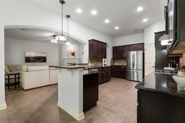 630 Wild Rose Dr, Austin, TX 78737 - kitchen featuring stainless steel appliances, arched walkways, ceiling fan, dark brown cabinetry, and open floor plan