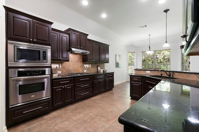 630 Wild Rose Dr, Austin, TX 78737 - kitchen with stainless steel appliances, backsplash, dark brown cabinetry, pendant lighting, and light tile patterned flooring