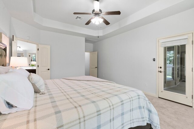630 Wild Rose Dr, Austin, TX 78737 - carpeted bedroom featuring a raised ceiling, multiple windows, and a ceiling fan