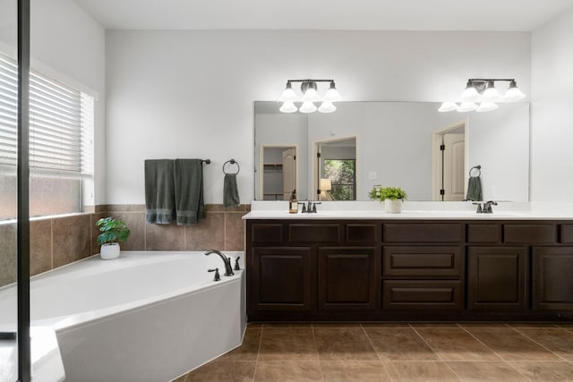 630 Wild Rose Dr, Austin, TX 78737 - bathroom featuring double vanity, a bath, tile patterned flooring, and a chandelier