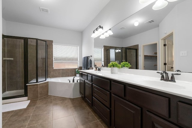 630 Wild Rose Dr, Austin, TX 78737 - full bath featuring double vanity, a bath, tile patterned floors, a shower stall, and a spacious closet