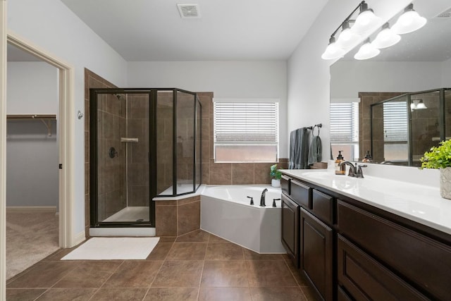 630 Wild Rose Dr, Austin, TX 78737 - full bath with a garden tub, vanity, a shower stall, a walk in closet, and tile patterned flooring