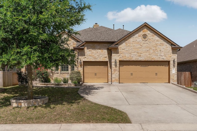 630 Wild Rose Dr, Austin, TX 78737 - view of front of house with stone siding, concrete driveway, an attached garage, and a chimney