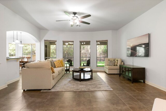 630 Wild Rose Dr, Austin, TX 78737 - living area with a ceiling fan, dark tile patterned floors, and arched walkways